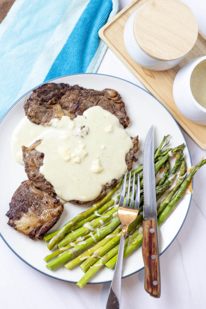 black and blue steak with cheese asparagus