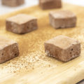 chocolate brownie batter marshmallows on a cutting board with cocoa powder