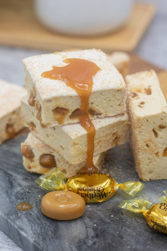 Caramel crunch marshmallows in a stack with caramel sauce dripping down