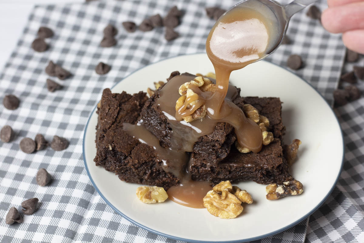 salted caramel sauce drizzled on brownies with nuts