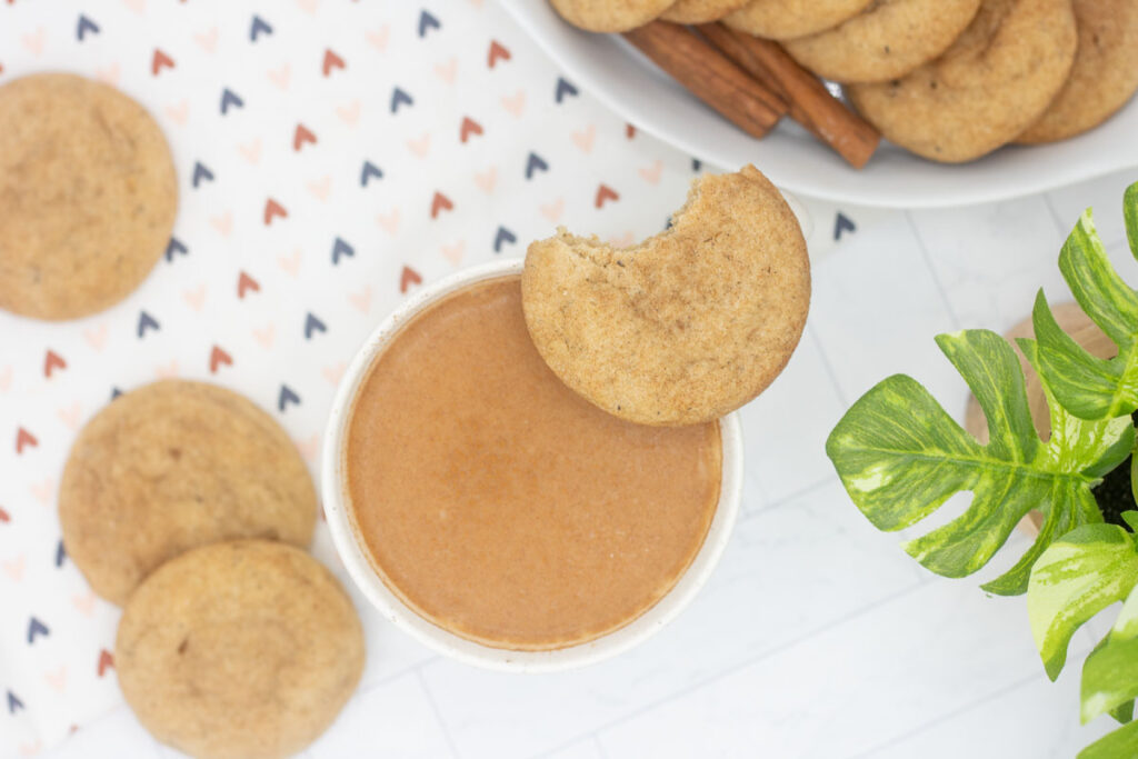 Top down view of a chai snickerdoodle with a bite taken out of it resting on a mug