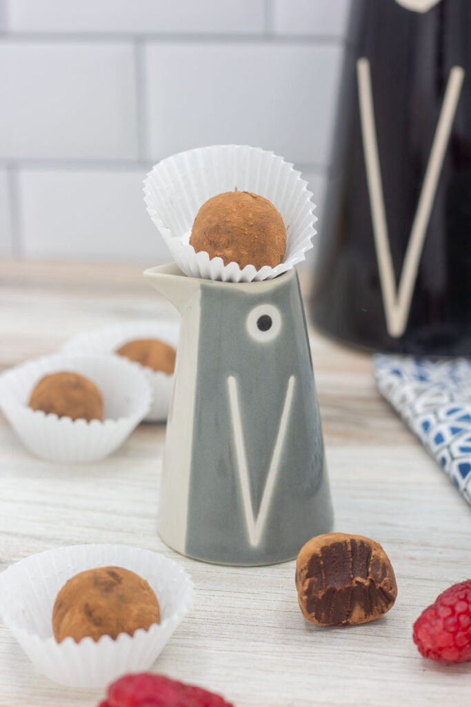 Raspberry truffle on a little ceramic penguin head