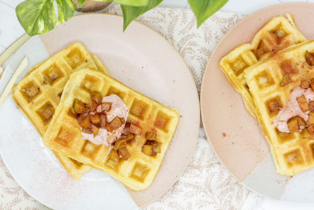 Fresh, stuffed cheesecake waffles topped with strawberry cream cheese and cinnamon apples