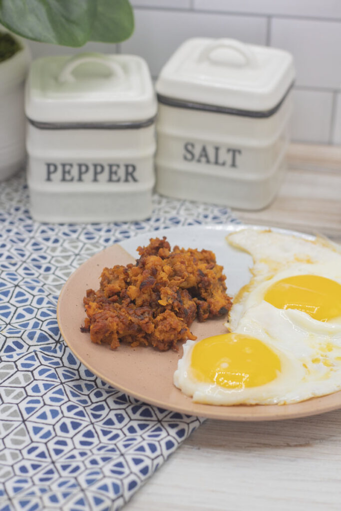 A breakfast plate of sweet potato chorizo hash and eggs