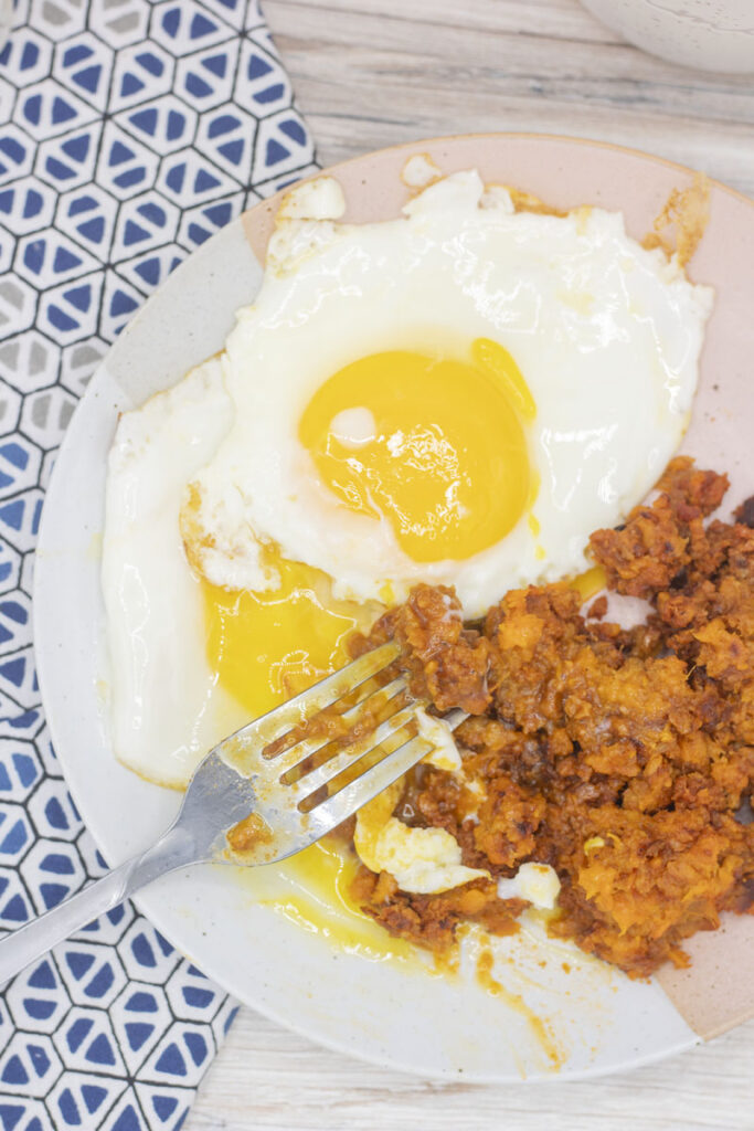 Runny sunny side up egg with chorizo sweet potato hash