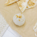 Cinnamon bun truffle on brown parchment paper