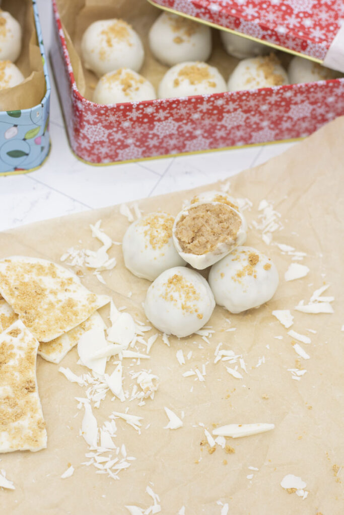 Assorted cinnamon bun truffles with one with a bite taken out of it