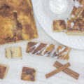 Loaf of focaccia beside breadsticks and cubed cinnamon focaccia