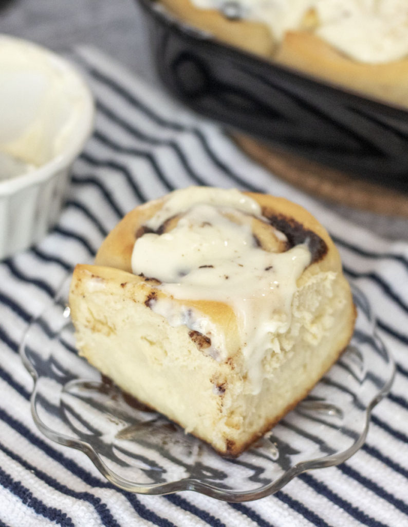 Fluffy cinnamon roll with icing dripping down