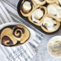 Cinnamon rolls with icing nearby