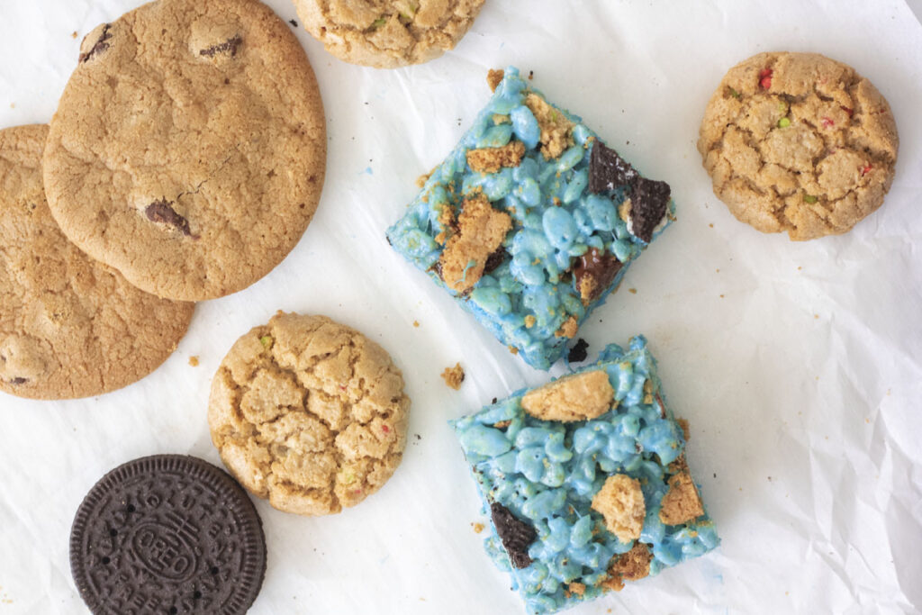 cookie monster krispie treats amidst an assortment of cookies