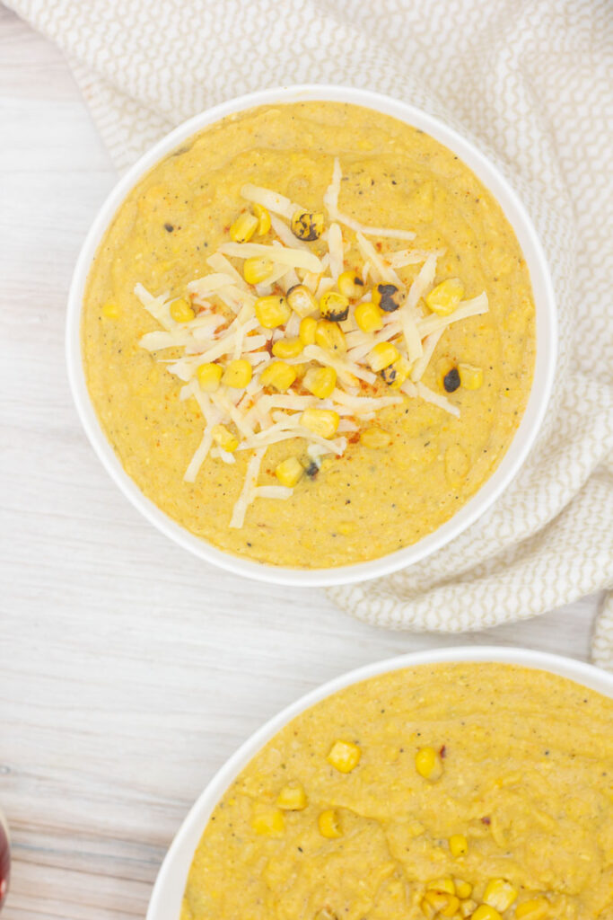 Healthful corn chowder topped with cheese and charred corn
