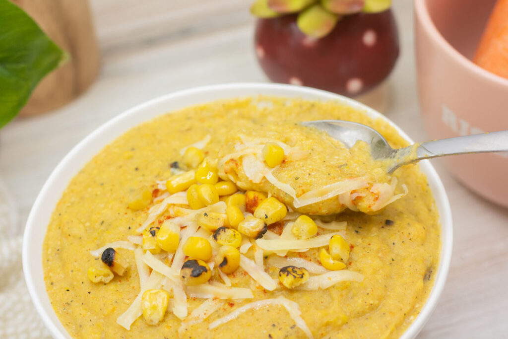 Spoon scooping some delicious corn chowder from a bowl