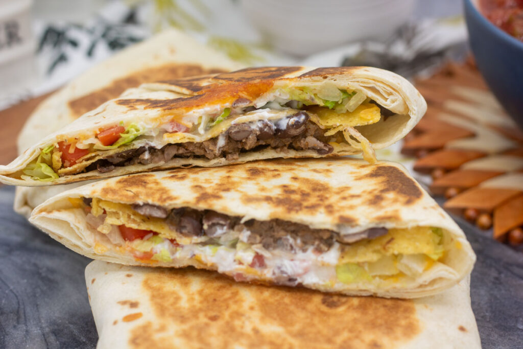 Crunchwrap supremes cut in half and stacked to see the layers