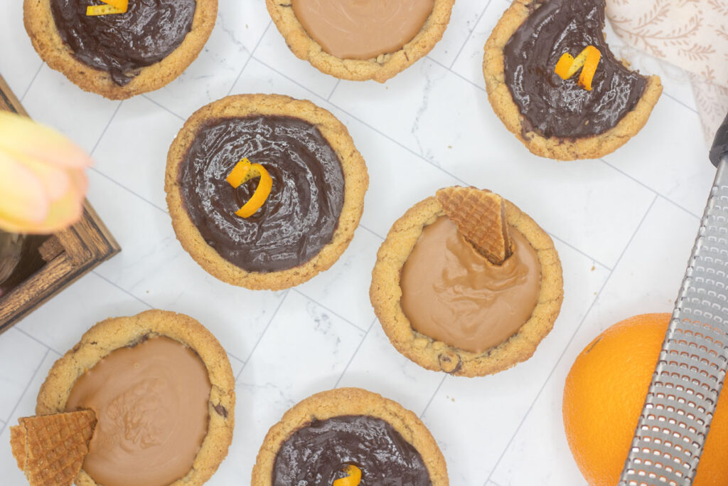Mini deep dish cookie pies filled with orange chocolate ganache and biscoff spread
