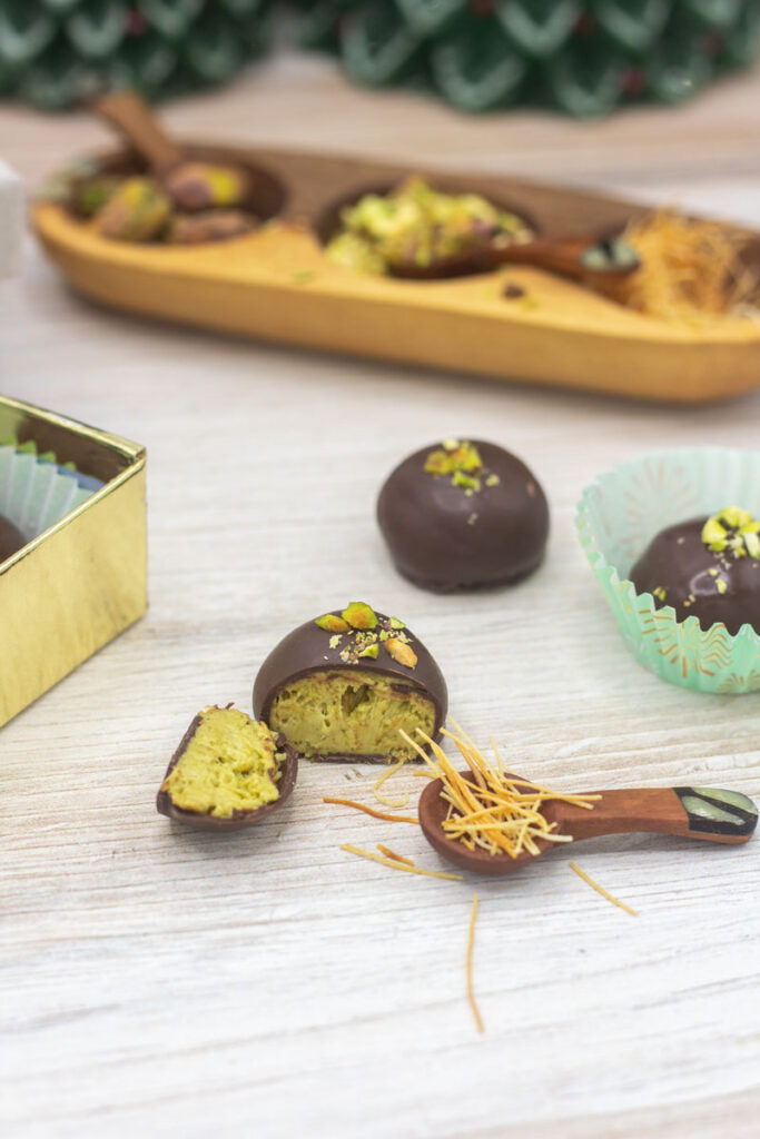 Dubai pistachio truffles with a tiny spoon full of kataifi dough strands nearby