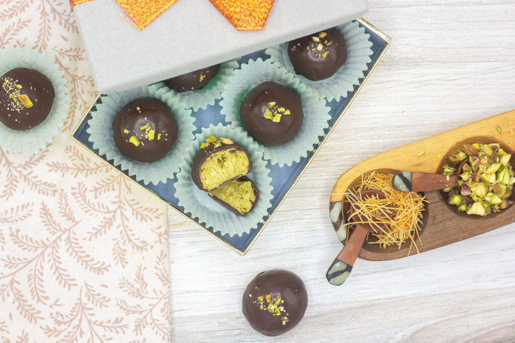 Dubai pistachio truffles in a gift box with kataifi nearby