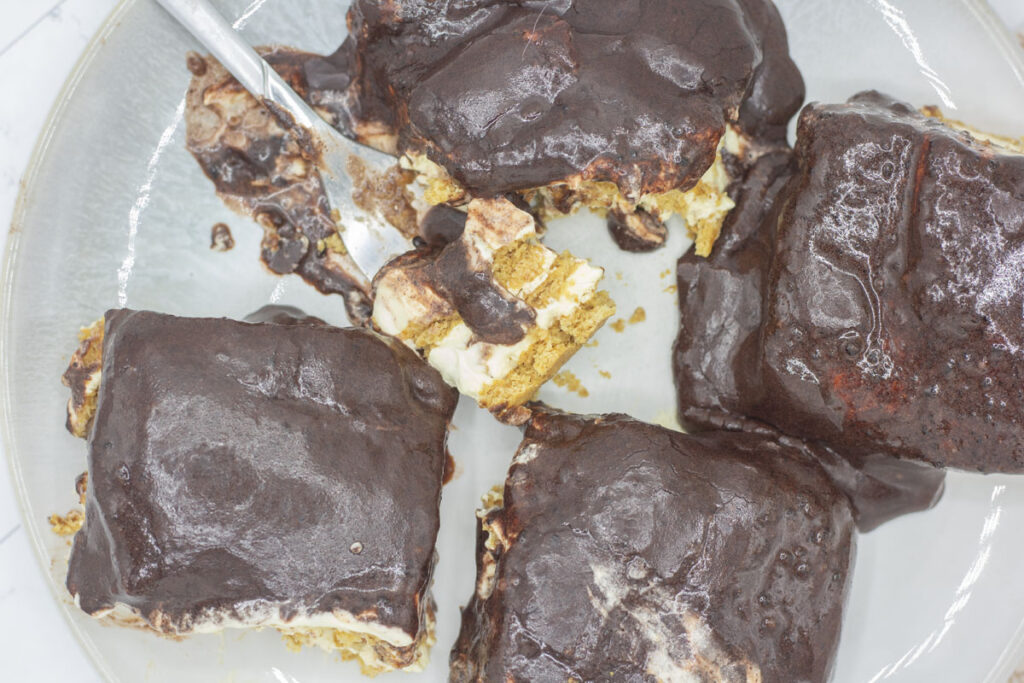 Assorted slices of eclair cake with a forkful in the middle