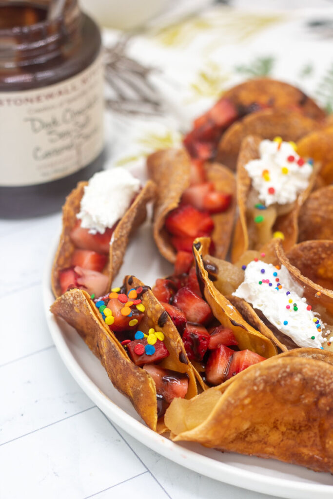 Colorful fruit tacos with toppings
