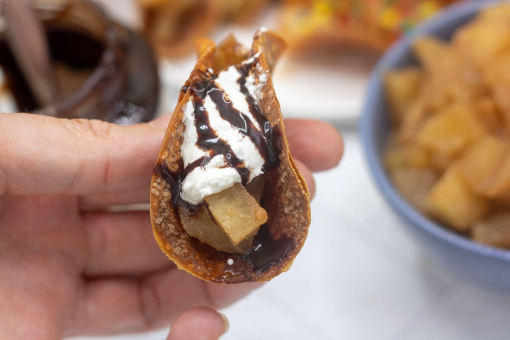 Apple pie taco with whipped cream and chocolate caramel drizzle
