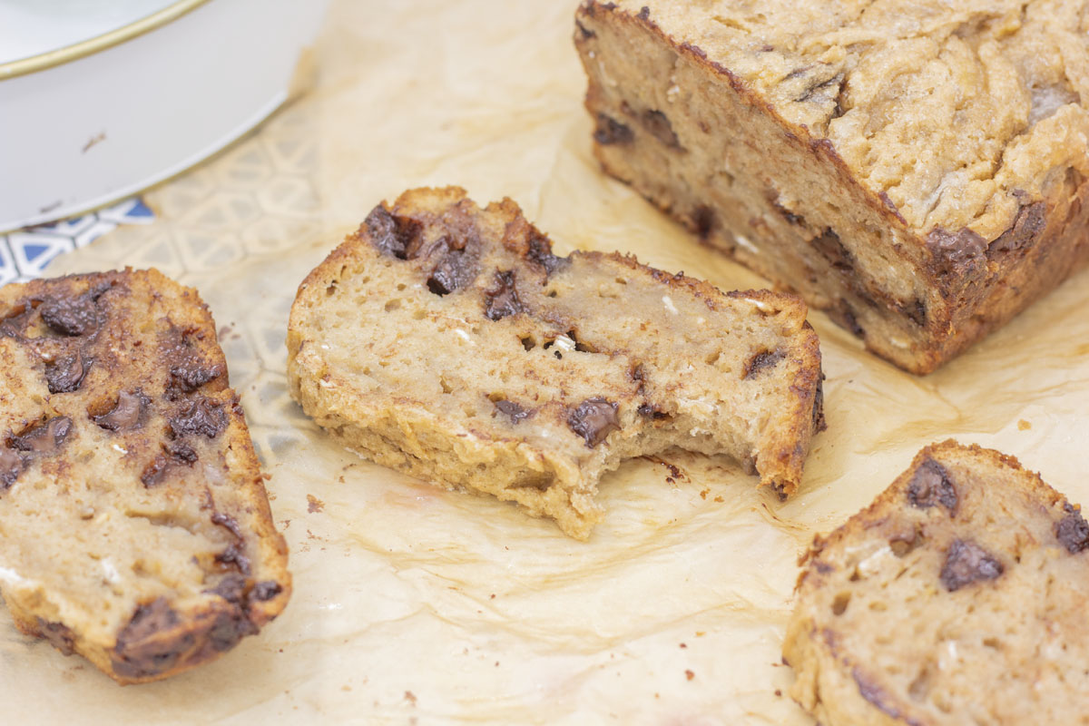 Slice of healthy chocolate chip banana bread with a bite taken out of it