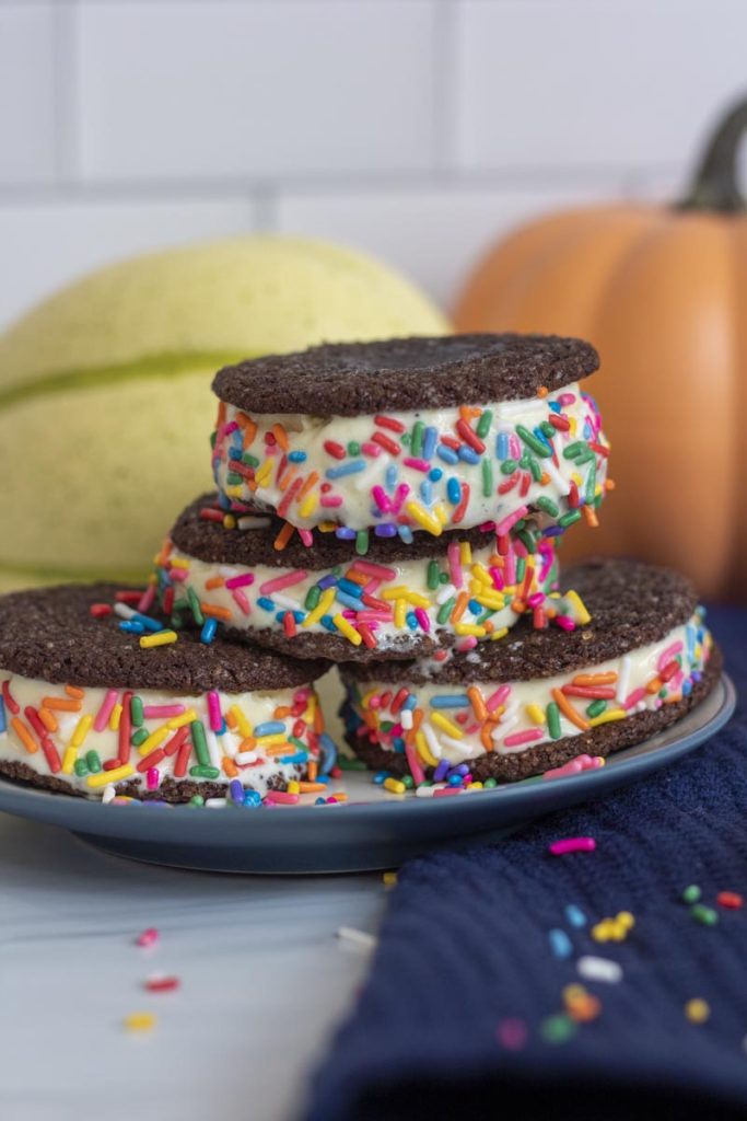 chocolate cookie ice cream sandwiches stacked on a plate