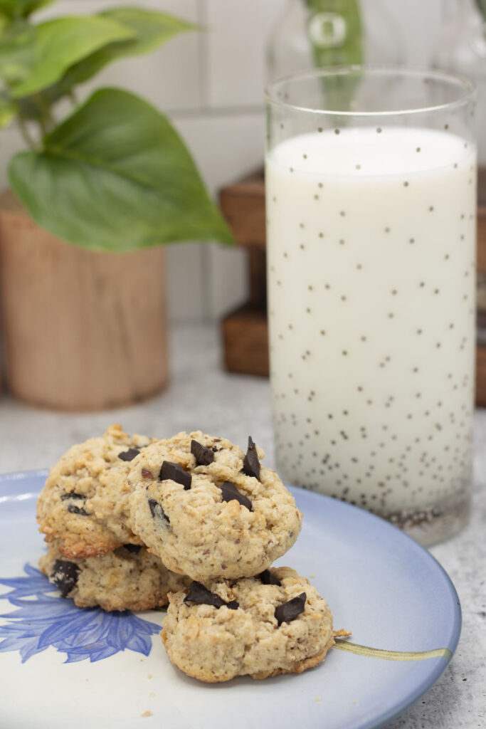 Stack of healthful chocolate chip cookies beside a glass of milk