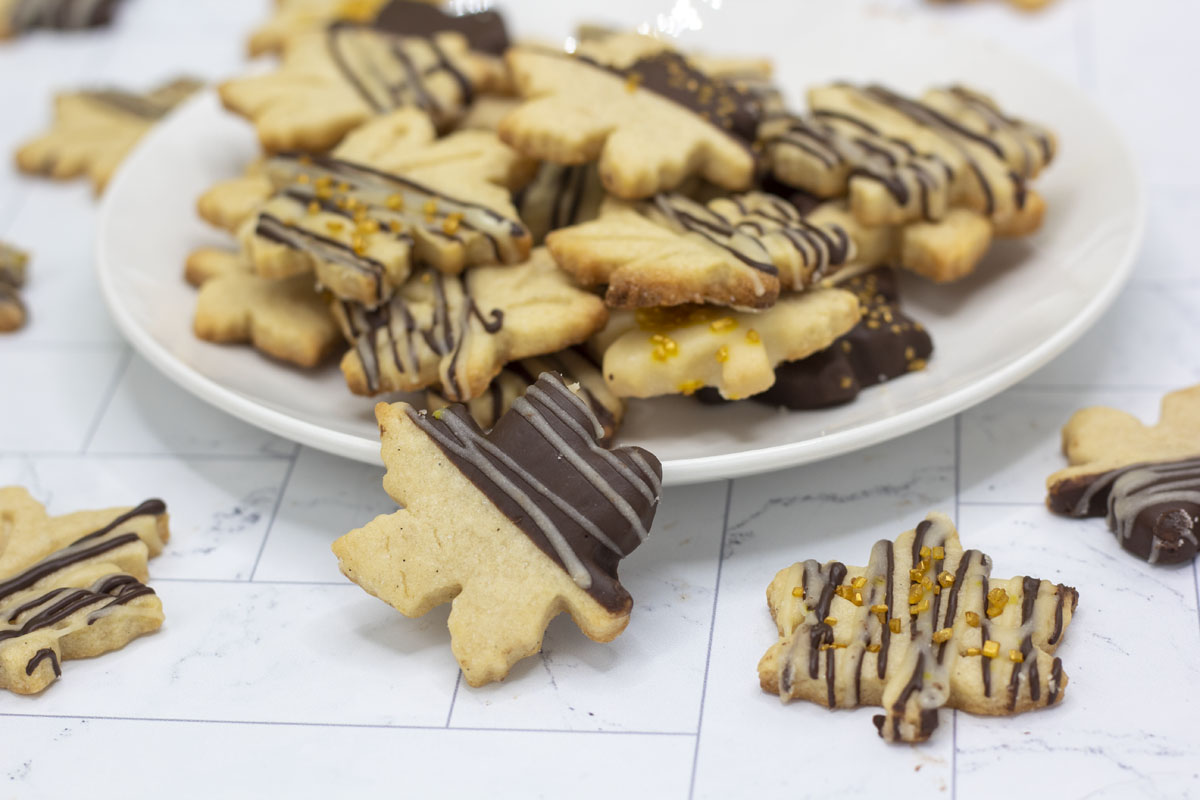 Plate stacked high with chocolate dipped maple cookies