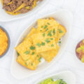 Mexican cornbread topped with cilantro amongst taco fillings