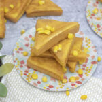 Stack of mochi cornbread littered with sweet corn