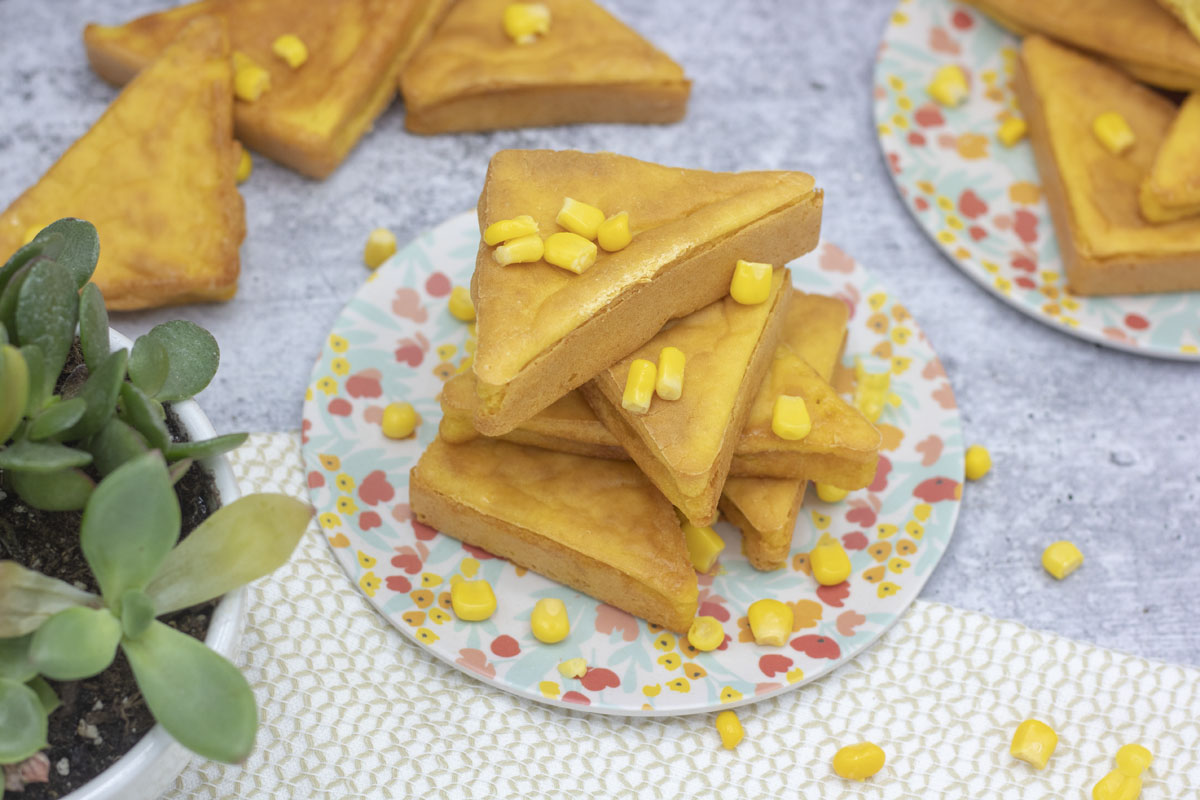 Stack of mochi cornbread littered with sweet corn