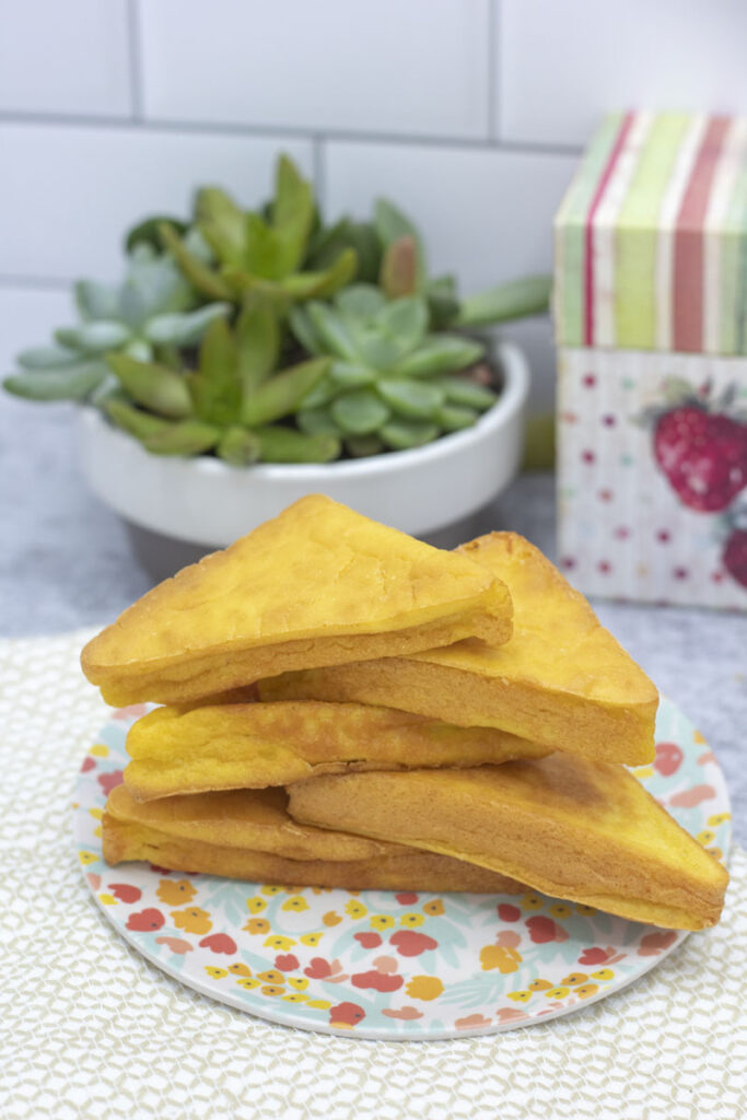 Stacked mochi cornbread on a flowery plate