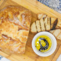 No knead sourdough bread with grilled slices alongside dipping oil