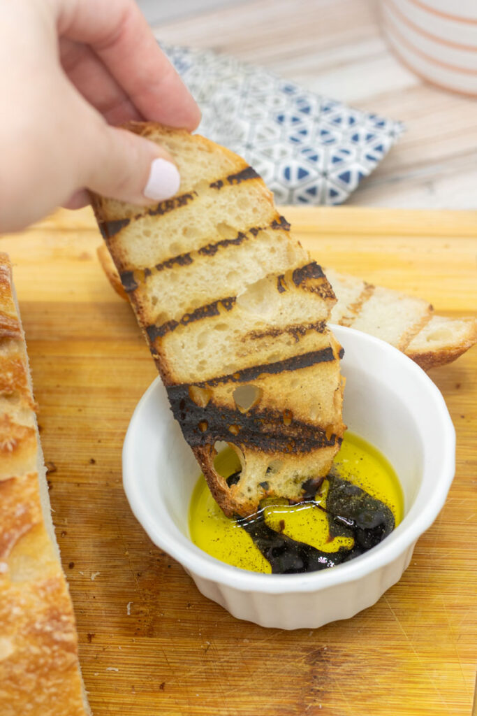 Grilled sourdough bread dipped in olive oil and balsamic vinegar
