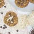 Oatmeal scattered about oatmeal cookies with chocolate chips