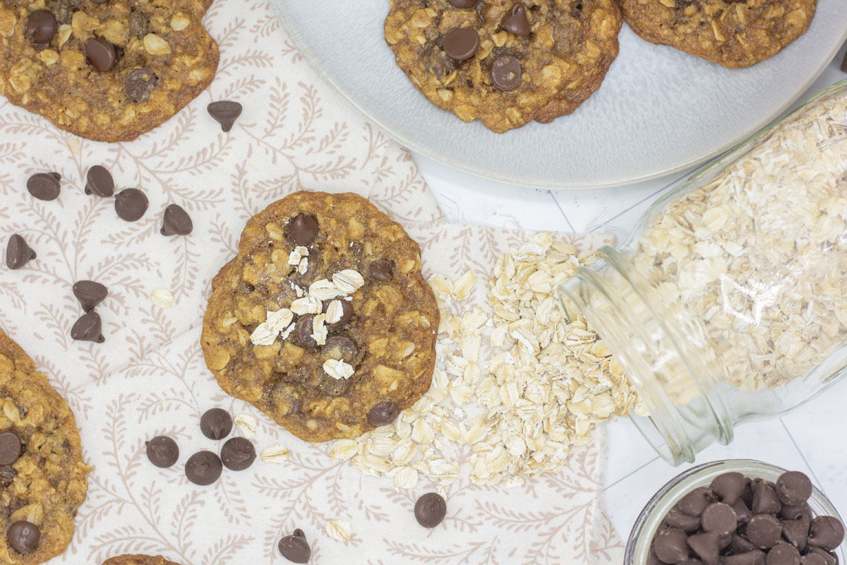 Oatmeal scattered about oatmeal cookies with chocolate chips