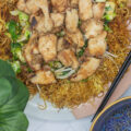 Pan fried noodles topped with chicken and vegetables