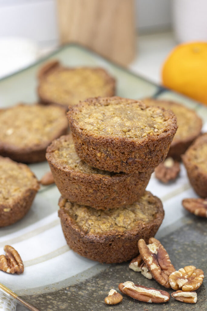 a stack of small brown pecan pie muffins