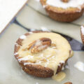 Pecan muffins topped with maple icing and a pecan