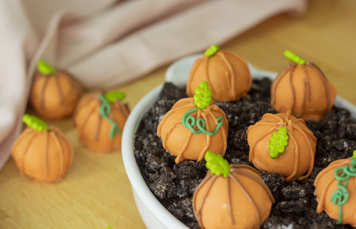 Pumpkin patch truffles decorated with candy leaves and green chocolate vines