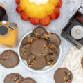 Pumpkin spice chocolate patties stacked on a plate and scattered around