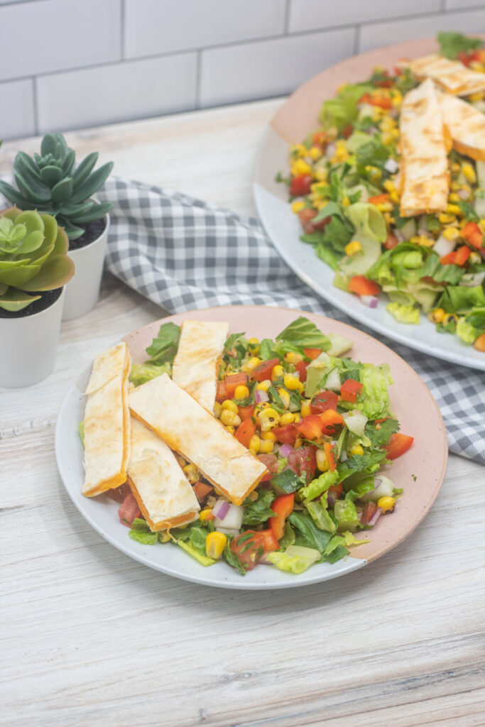 Southwest salad with quesadilla strips on the side