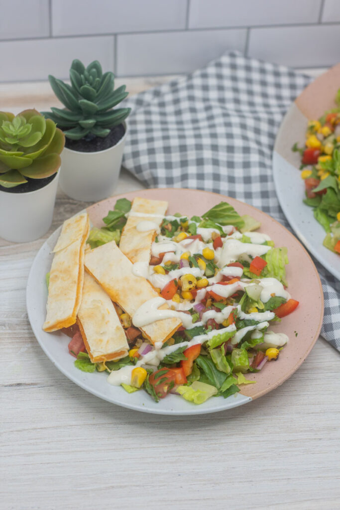 Southwest quesadilla salad drizzled with ranch dressing