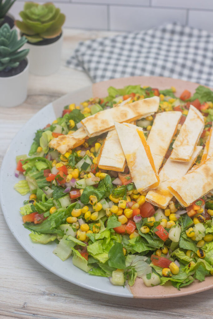 Quesadilla explosion salad with strips of cheese quesadilla