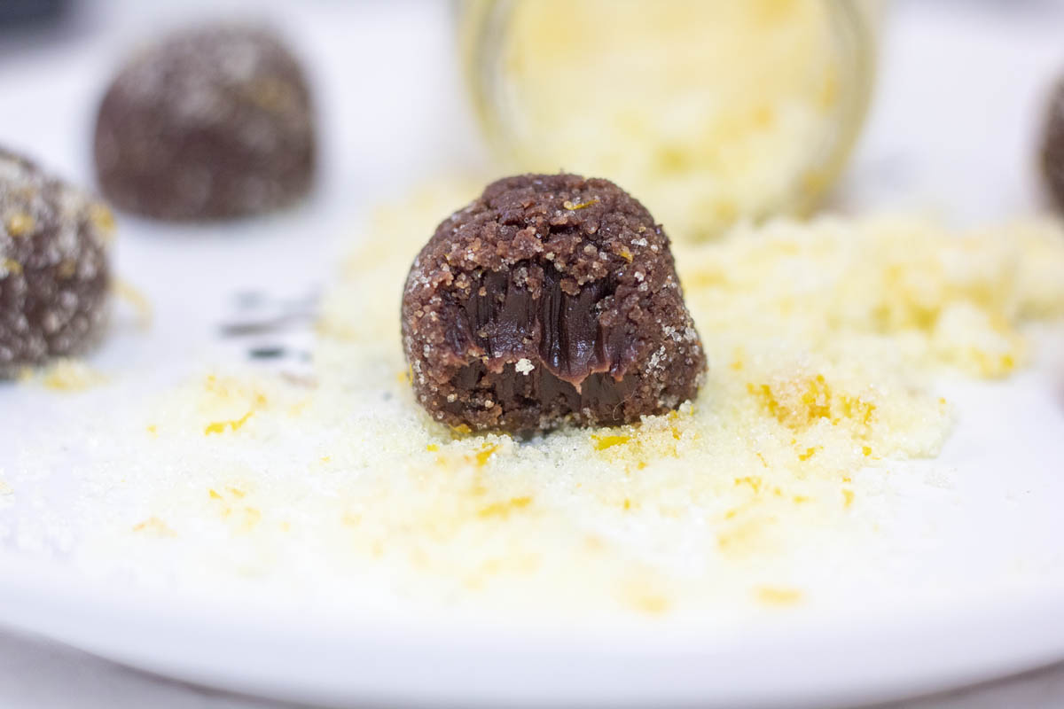 orange truffles rolled in sugar and bitten into