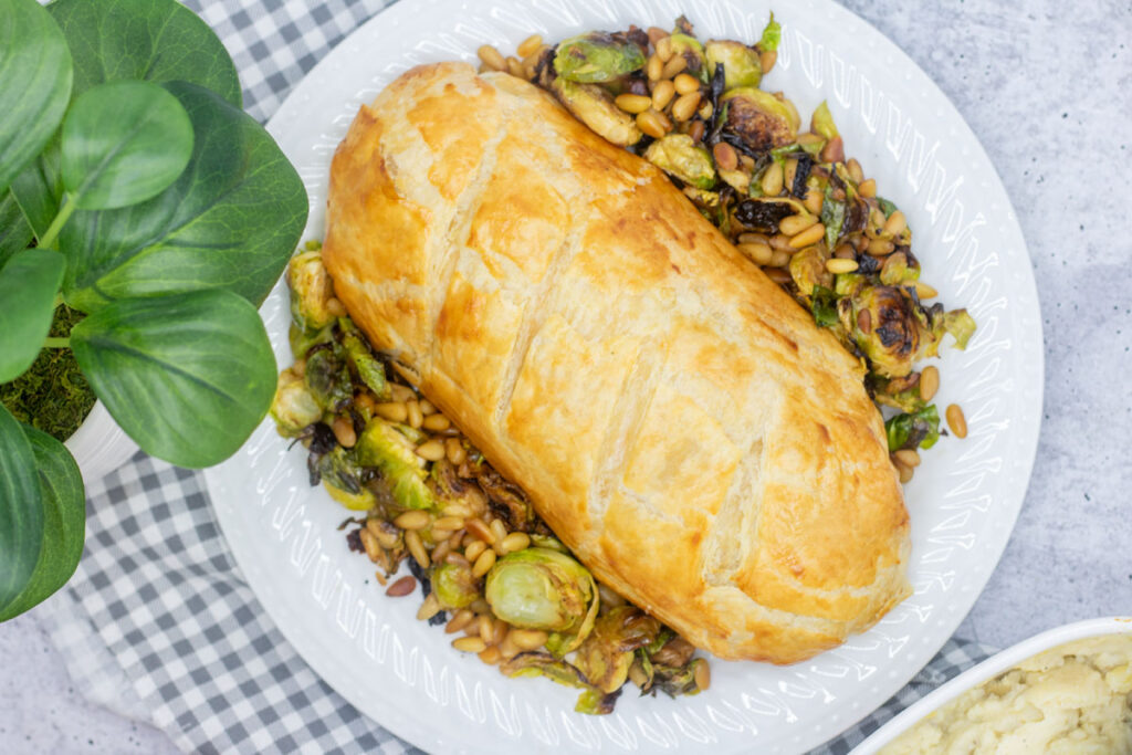 Salmon en croute on a bed of brussels sprouts