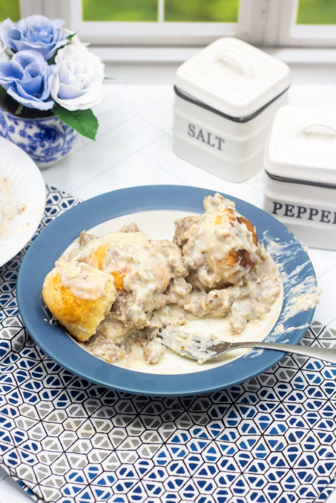 Spoon in a bowl of half eaten biscuits and gravy