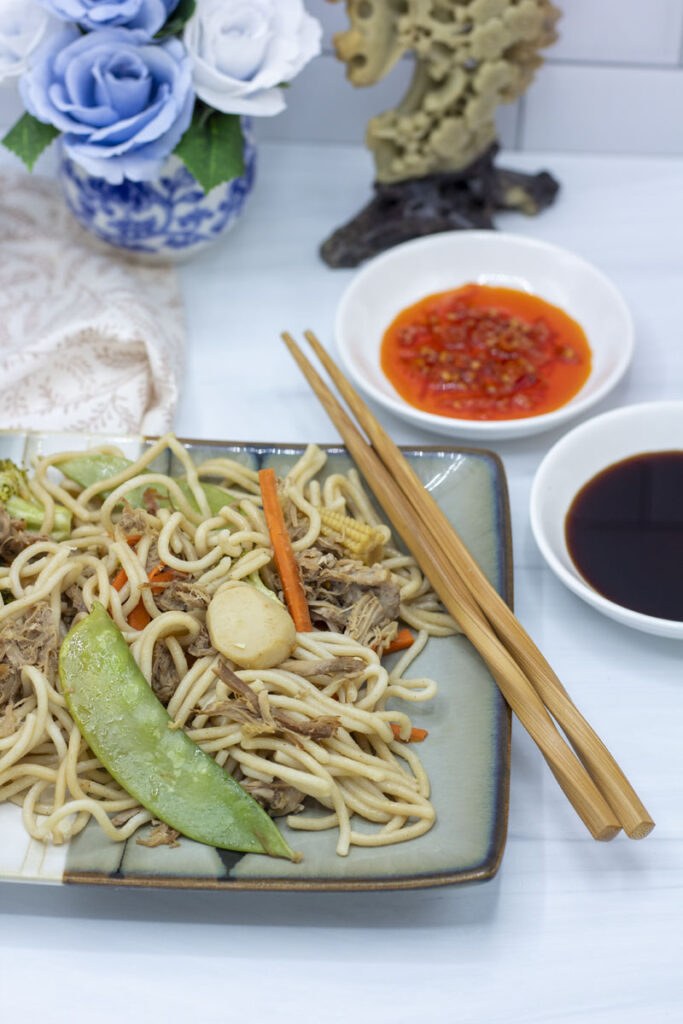 Slow cooker lo mein with chili oil and soy sauce dipping sauces