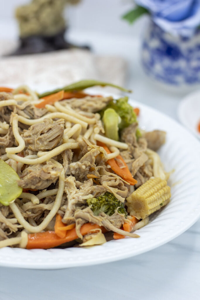Slow cooker lo mein with snow peas, pulled pork, baby corn, broccoli, and carrots