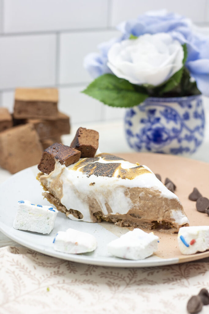 Slice of s'mores french silk pie with marshmallow fluff dripping down the side